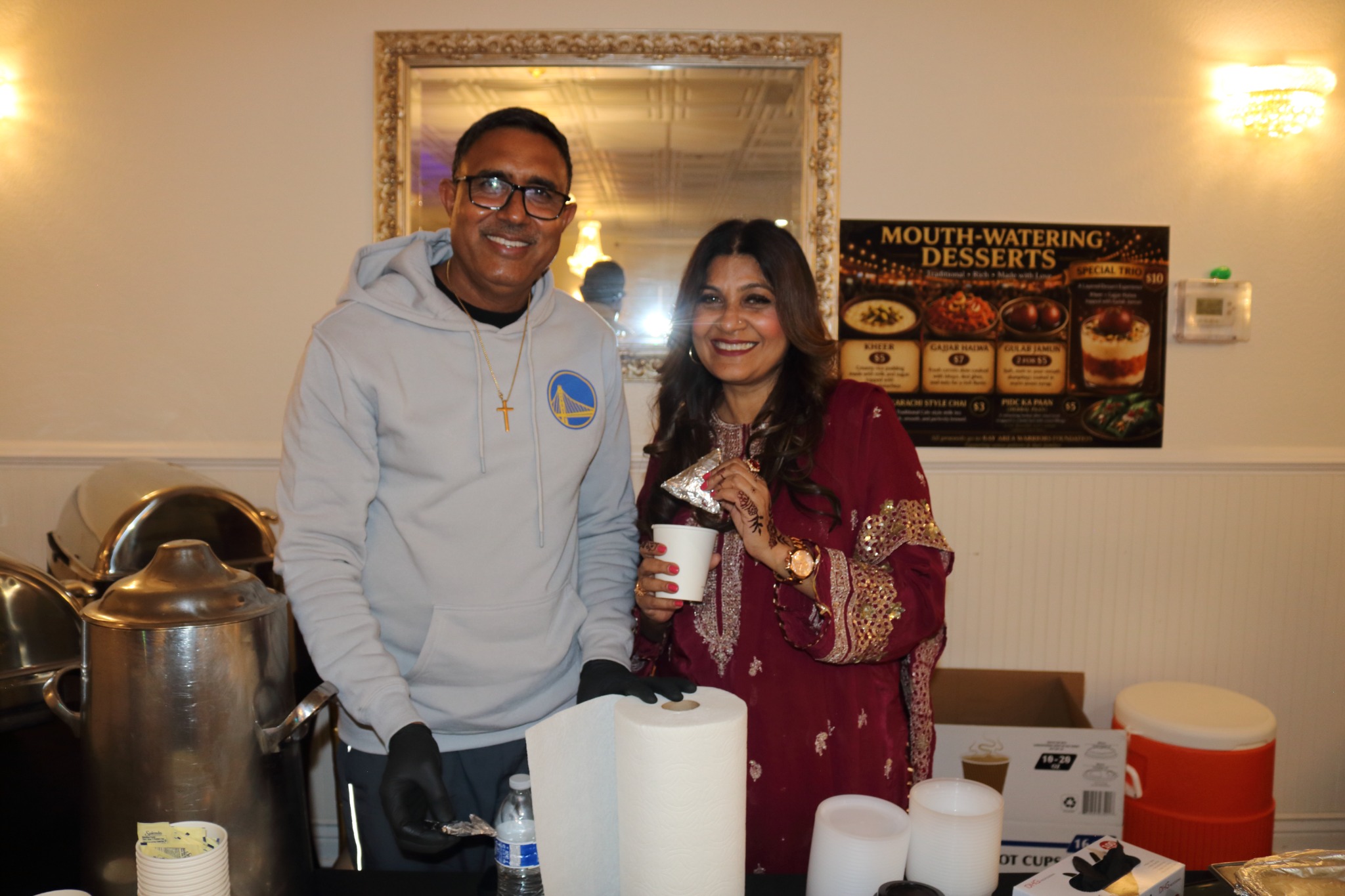 Two people at a food table